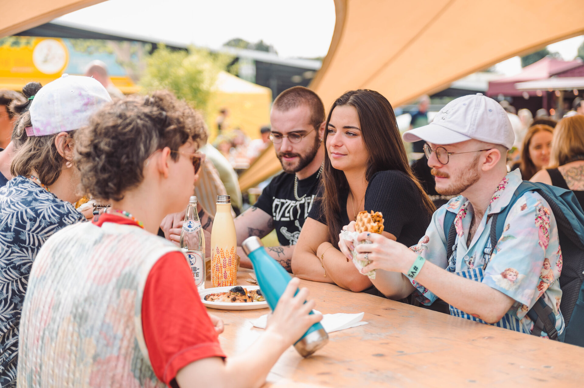 Vegan Summer Fest — friends sharing food together at a picnic table